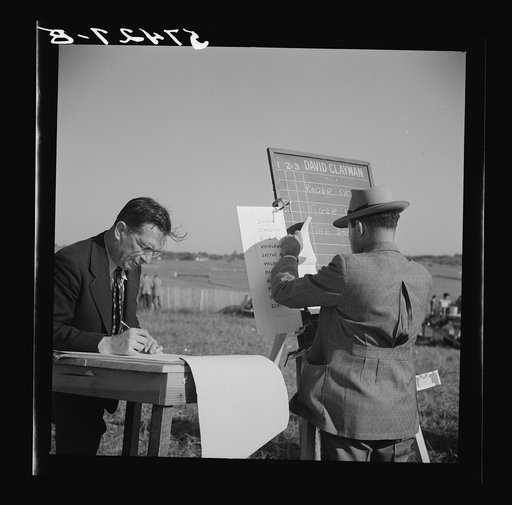 Bookie figuring out bets for Kentucky derby. Warrenton, Virginia.