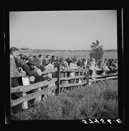 Spectators at paddock fence between races. Warrenton, Virginia