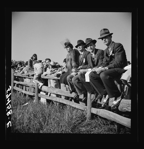 Spectators at paddock fence between races. Warrenton, Virginia