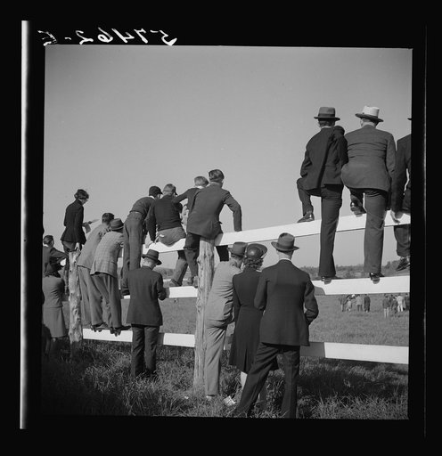 Spectators at paddock fence between races. Warrenton, Virginia
