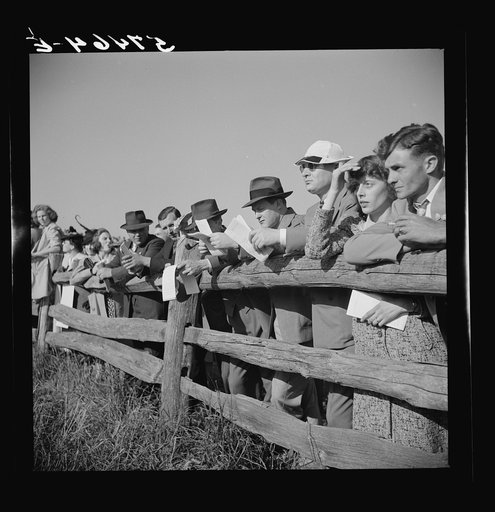 Spectators at paddock fence between races. Warrenton, Virginia