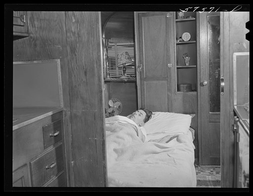 Frank Robbins of Wareham, Massachusetts, employed at United Aircraft, East Hartford, Connecticut, lives in trailer near plant, with wife and four children because of housing shortage. He works nights, so he can sleep days in a bed used at night by the children. He makes forty dollars a week, his tra