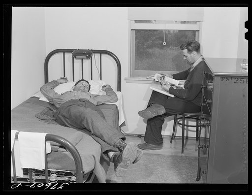 Workers from electric boat company plant relaxing in single room of new dormitories for defense workers. Groton, Connecticut. Constructed and managed by FSA (Farm Security Administration)