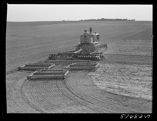 Harrowing fields with diesel tractors at Seabrook Farms. Bridgeton, New Jersey