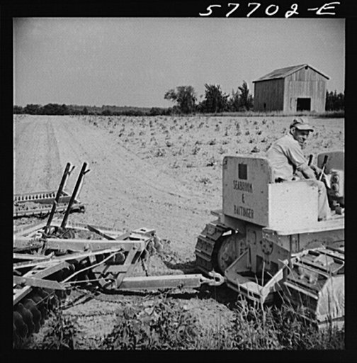 Harrowing fields with diesel tractors at Seabrook Farms. Bridgeton, New Jersey