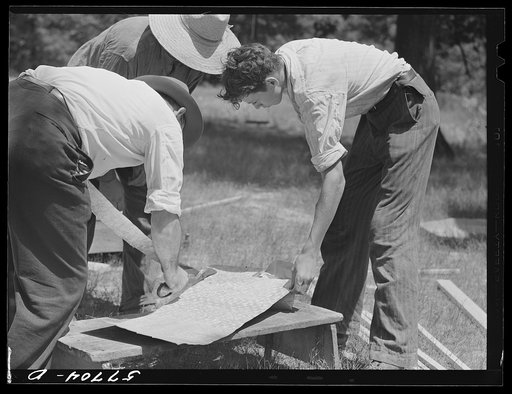 Cutting metal reinforcement for screen door joints. Charles County, La Plata, Maryland. Screening demonstration