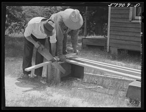 Untitled photo, possibly related to: Cutting screen door stock to measurement. Screening demonstration. Charles County, La Plata, Maryland