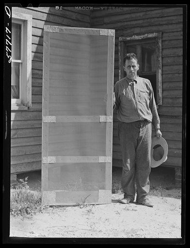 Door frame with screen wire assembled ready to fasten on hinge strip.  Screening demonstration. Charles County, La Plata, Maryland