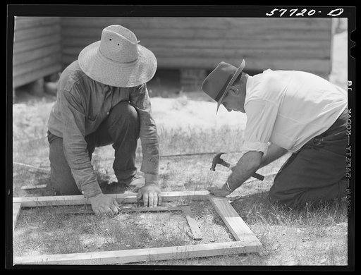 Nailing metal reinforcements to screen door joints on outside face of door. Screening demonstration. Charles County, La Plata, Maryland