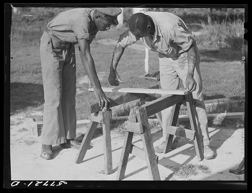 Measuring the top piece. Demonstration of home screen door construction. Saint Mary's County, Ridge, Maryland
