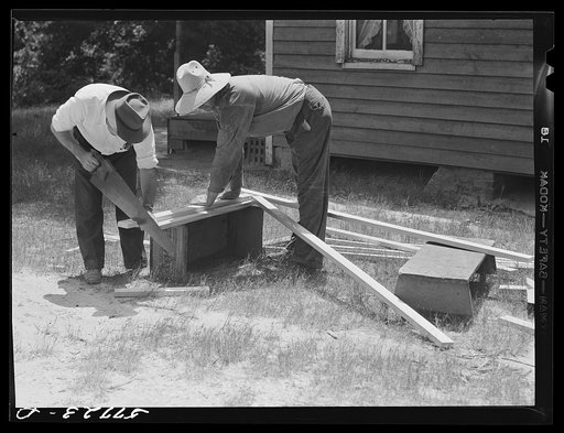 Cutting screen door stock to measurement. This material is known as 5/4 stock, three inches wide. Screening demonstration. Charles County, La Plata, Maryland