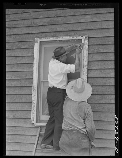 Side strips are nailed over the wire sceen to hold the edges down tightly.  A completed window screen. Screening demonstration. Charles County, La Plata, Maryland