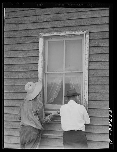 The window is screened except for nailing the last window strip. Screening demonstration. Charles County, La Plata, Maryland