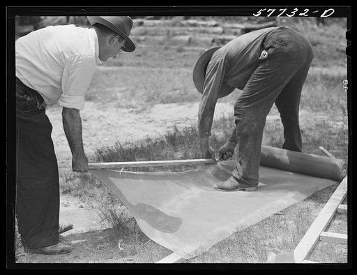 Assembling screen wire battens for covering window frames. Screening demonstration. Charles County, La Plata, Maryland