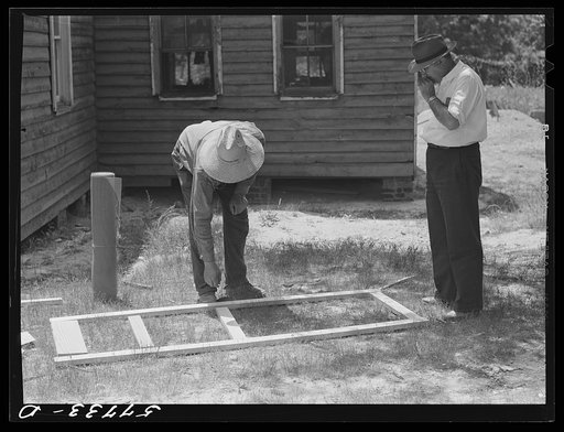 Untitled photo, possibly related to: Fastening the stock with corrugated staples. Screen door construction. Charles County, La Plata, Maryland