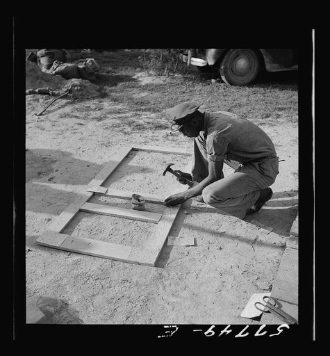 Fastening metal reinforcement to screen door joints. This metal is 24-gauge galvanized steel. Nails are easily punched through it. Screening demonstration. Saint Mary's County, Ridge, Maryland