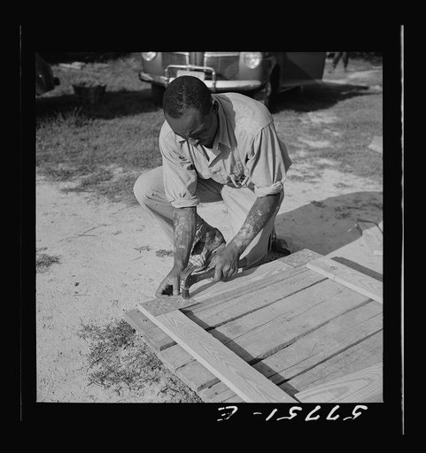 Untitled photo, possibly related to: Assembling a joint  of screen door. Screen door stock used in one inch by four inches. Joints are cut square and held together with corrugated fasteners. Screening demonstration. Saint Mary's County, Ridge, Maryland