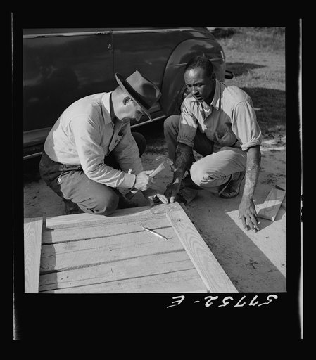 Nailing a joint of screen door. These doors are simple to build, require few tools, are durable and inexpensive. Screening demonstration. Saint Mary's County, Ridge, Maryland