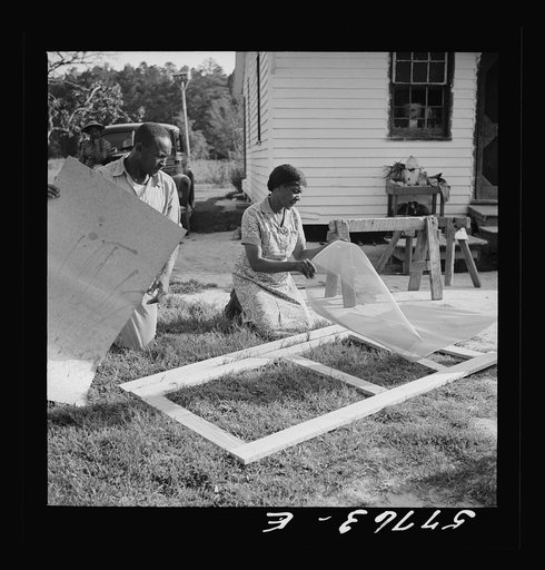 Untitled photo, possibly related to: Applying the screen on the inside face of door. Demonstration of home screen door construction. Saint Mary's County, Ridge, Maryland