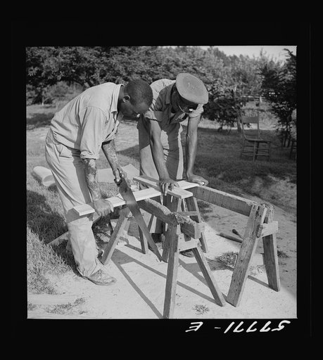 Cutting screen door stock to measurement. Screening demonstration. Saint Mary's County, Ridge, Maryland
