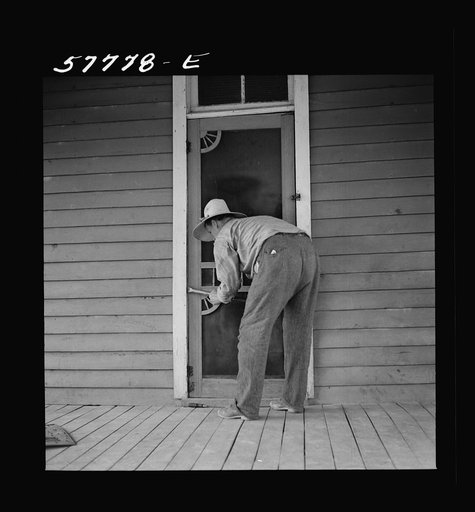 Removing the old worn-out door. Screen door construction demonstration. Charles County, La Plata, Maryland