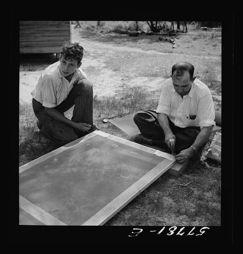 Untitled photo, possibly related to: Door frame with screen wire assembled ready to fasten on hinge strip. Screening demonstration. Charles County, La Plata, Maryland
