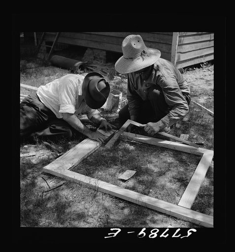 The corner is squared and reinforcement nailed over joints. Screen door construction demonstration. Charles County, La Plata, Maryland