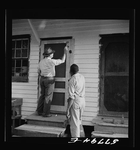 Nailing the hinge strip to the door frame. Saint Mary's County, Ridge, Maryland. Screening demonstration