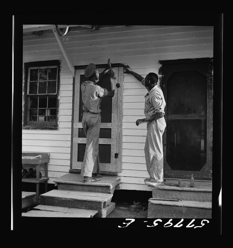 Door in place. Applying closing strips. Demonstration of home screen door construction, Saint Mary's County, Ridge, Maryland