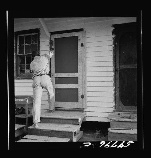 Assembling screen door to door frame. Screening demonstration. Saint Mary's County, Ridge, Maryland