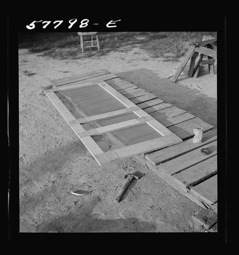 Screen door assembled. The hinge strip, handles, and coil spring remain to be assembled to complete the door. Saint Mary's County, Ridge, Maryland. Screening demonstration