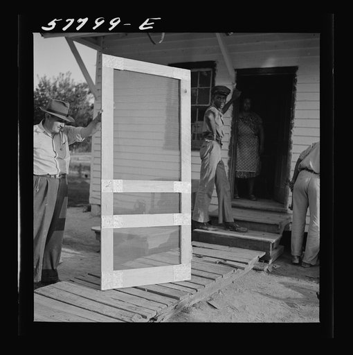 Door ready to attach to hinge strip. Demonstration of home screen door construction. Saint Mary's County, Ridge, Maryland