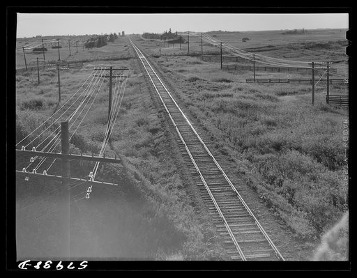 Untitled photo, possibly related to: Railroad with grain elevators near Minot, North Dakota