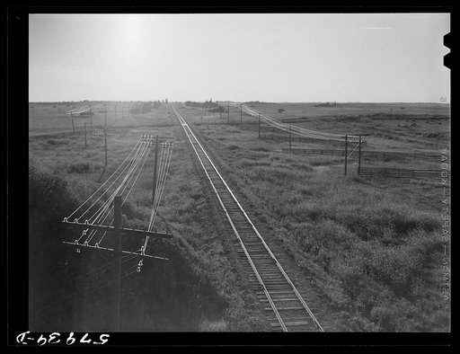 Untitled photo, possibly related to: Railroad with grain elevators near Minot, North Dakota