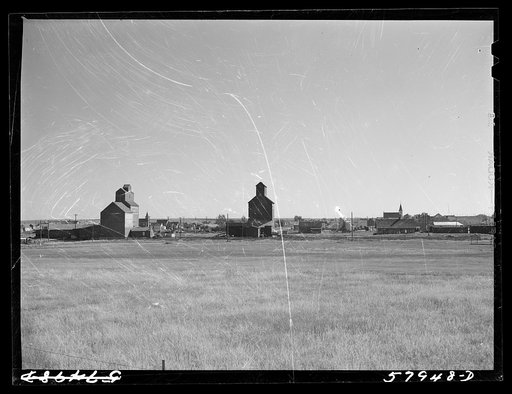 Untitled photo, possibly related to: Grain storage elevators in town in northwestern North Dakota