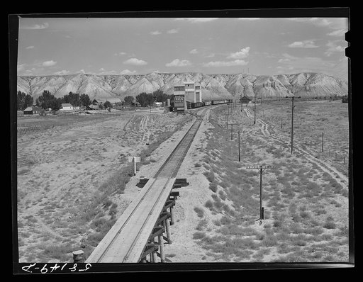 Grain storage elevators, freight car and railroad station. Loma, Montana