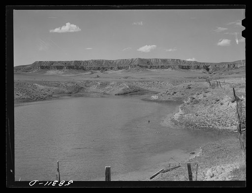 Reservoir for cattle and grazing land on Indian reservation near Crow Agency, Montana