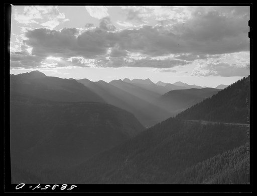 General view of Rocky Mountains at sundown west of Continental Divide seen from top of Logan Pass en route to the Sun highway. Glacier National Park, Montana