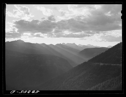 General view of Rocky Mountains at sundown west of Continental Divide seen from top of Logan Pass en route to the Sun highway. Glacier National Park, Montana