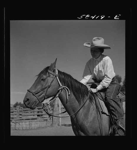 Mrs. Lyman Brewster on a ranch horse. In the corral at Quarter Circle U Ranch. Birney, Montana