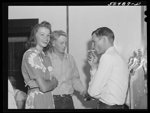 Dude girl with two cowboys at a Saturday night dance in Birney, Montana
