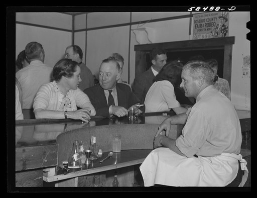 Mrs. Lyman Brewster talking with an acquaintance at the bar in Birney, Montana