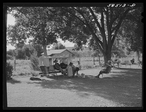Guest resting on the lawn with Mrs. Jack Arnold at Quarter Circle U Ranch. Birney, Montana