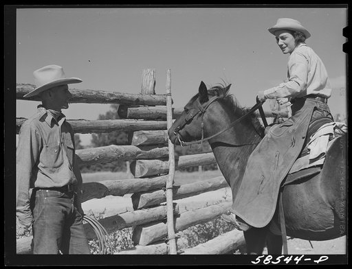 Untitled photo, possibly related to: Dudes saddling horses in the corral before going for a ride, over the range. Quarter Circle U, Brewster-Arnold Ranch Company. Birney, Montana