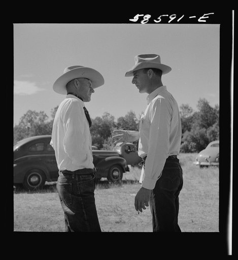 Untitled photo, possibly related to: Lyman Brewster from Quarter Circle U Ranch in Birney, Montana, talking to a neighbor stockman at stockmen's picnic and barbecue. Spear's Siding, Wyola, Montana