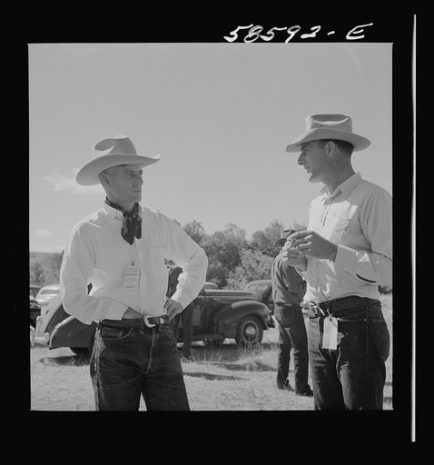 Untitled photo, possibly related to: Lyman Brewster from Quarter Circle U Ranch in Birney, Montana, talking to a neighbor stockman at stockmen's picnic and barbecue. Spear's Siding, Wyola, Montana