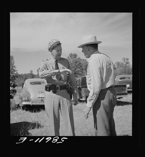 Policeman with friend at stockmen's picnic and barbecue. Spear's Siding, Wyola, Montana