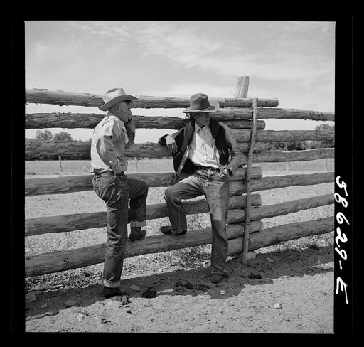 Lyman Brewster talking with a Cheyenne Indian who wants to buy one of his horses. In the corral at Quarter Circle U, Brewster-Arnold Ranch Company. Birney, Montana