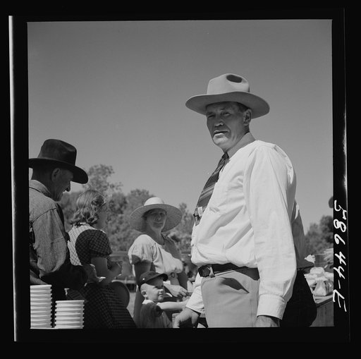 Untitled photo, possibly related to: Waiting in line for barbecued beef at the stockmen's picnic and barbecue. Spear's Siding, Wyola, Montana