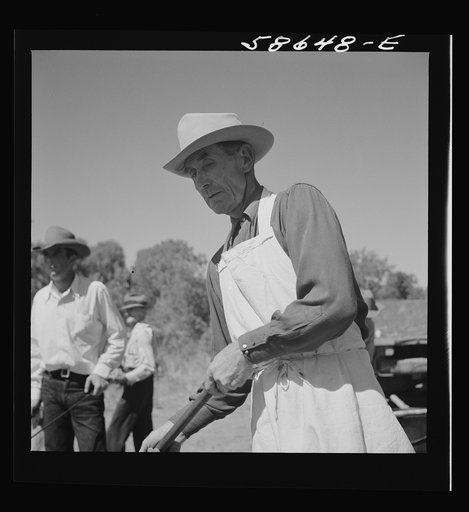 Untitled photo, possibly related to: The chef barbecuing beef at the stockmen's picnic and barbecue. Spear's Siding, Wyola, Montana